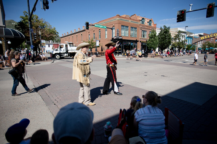 Buzz, left, and Jason Baker walk around Buffalo Bill Days in costume, waving to people before the start of the parade Saturday morning.